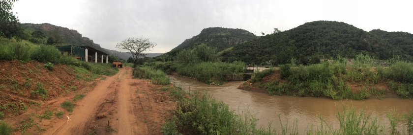 The road along the Umzimkulu River next to the banana plantation. The narrow waterway pictured is part of the farmer's local hydroelectric dam which powers the irrigation system. 